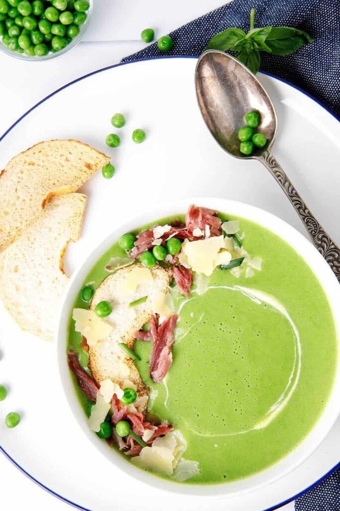 Say hello to my vibrant green, Thermomix pea and ham soup this winter. It's full of delicious pulled ham and topped with bagel croutons, sour cream and parmesan cheese. Can be made on the stove too! #Thermomix #soup #peaandhamsoup
